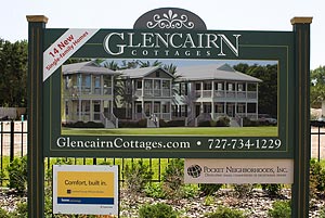 photo of sign with renderings of Glencairn Cottages.