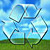 Icon of recycle logo on top of green land and blue sky