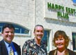 Photo of Happy Feet Plus three owners standing outside of retail building.